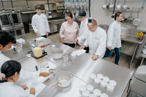 Culinary teacher instructing students during class.