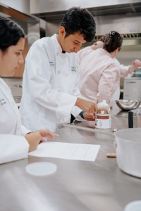 Student measuring ingredients for cooking class.