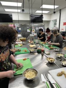 Students cutting ingredients for culinary class.