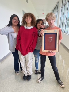 Students holding a screen print