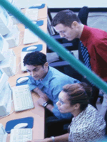 Employees collaborating around computer