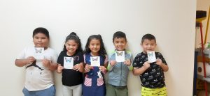 students display their drawings of butterflies