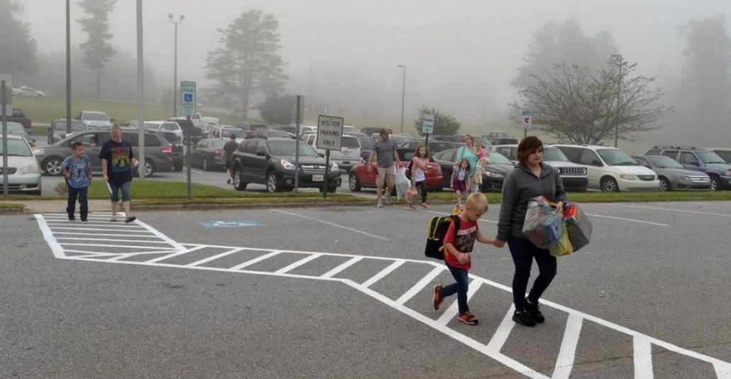 Kids and parents at school entrance crosswalk