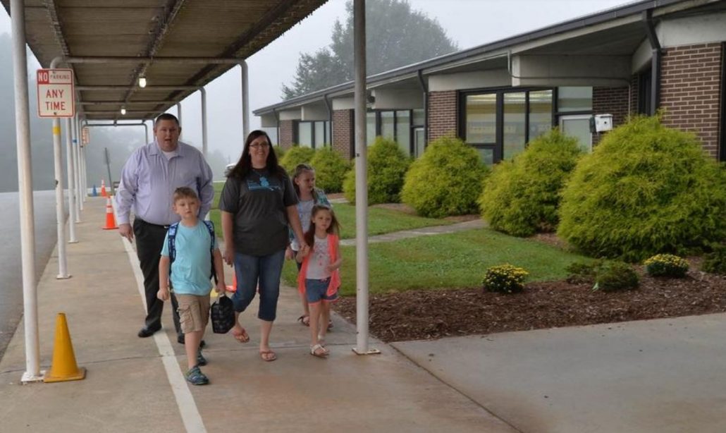Parents and children on sidewalk