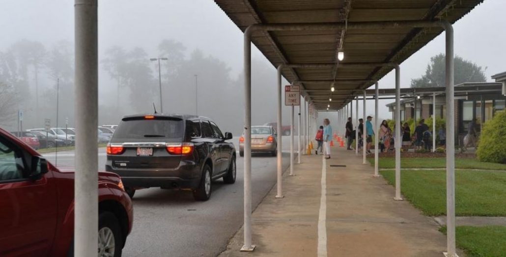 Cars driving up to bring students to school