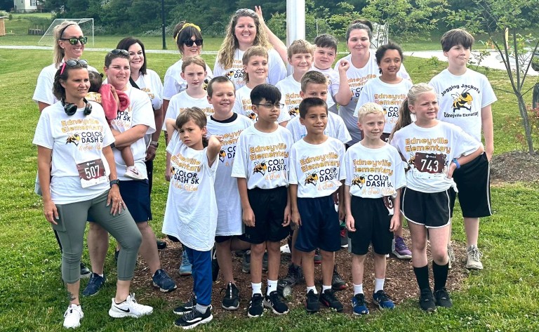 Teachers and students wearing white shirts that read Color Dash 5k