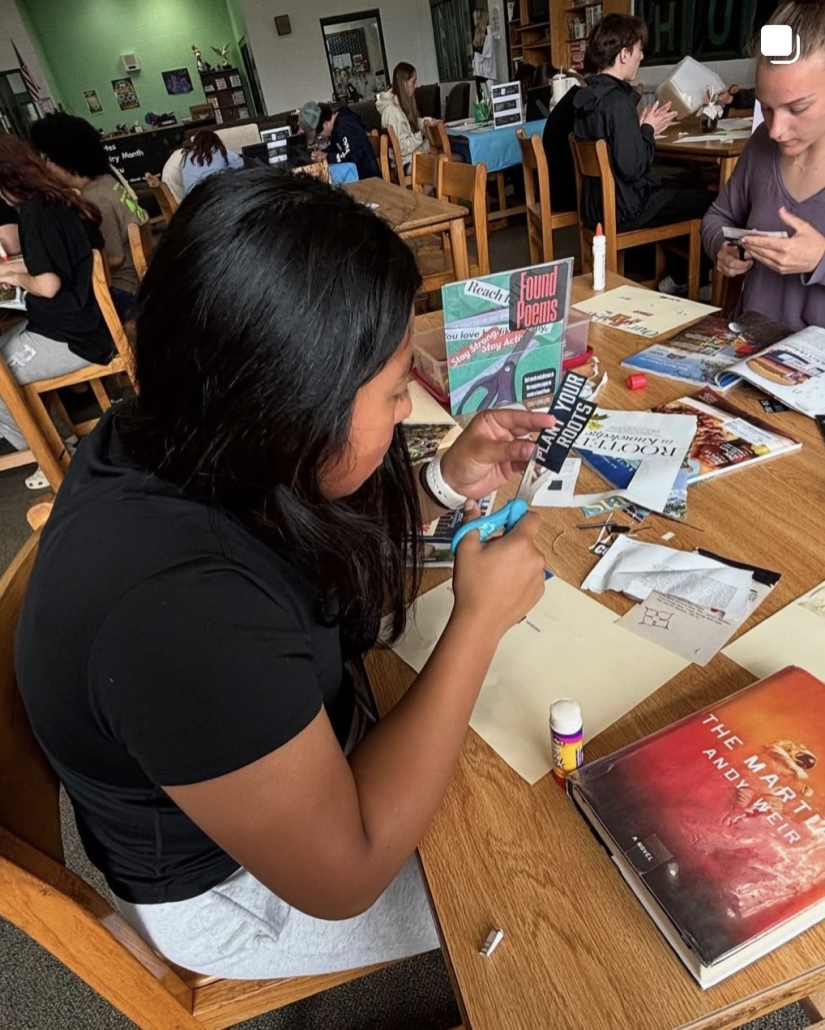 student cutting out magazine clipping