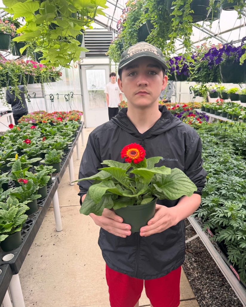 student holding up daisy 2