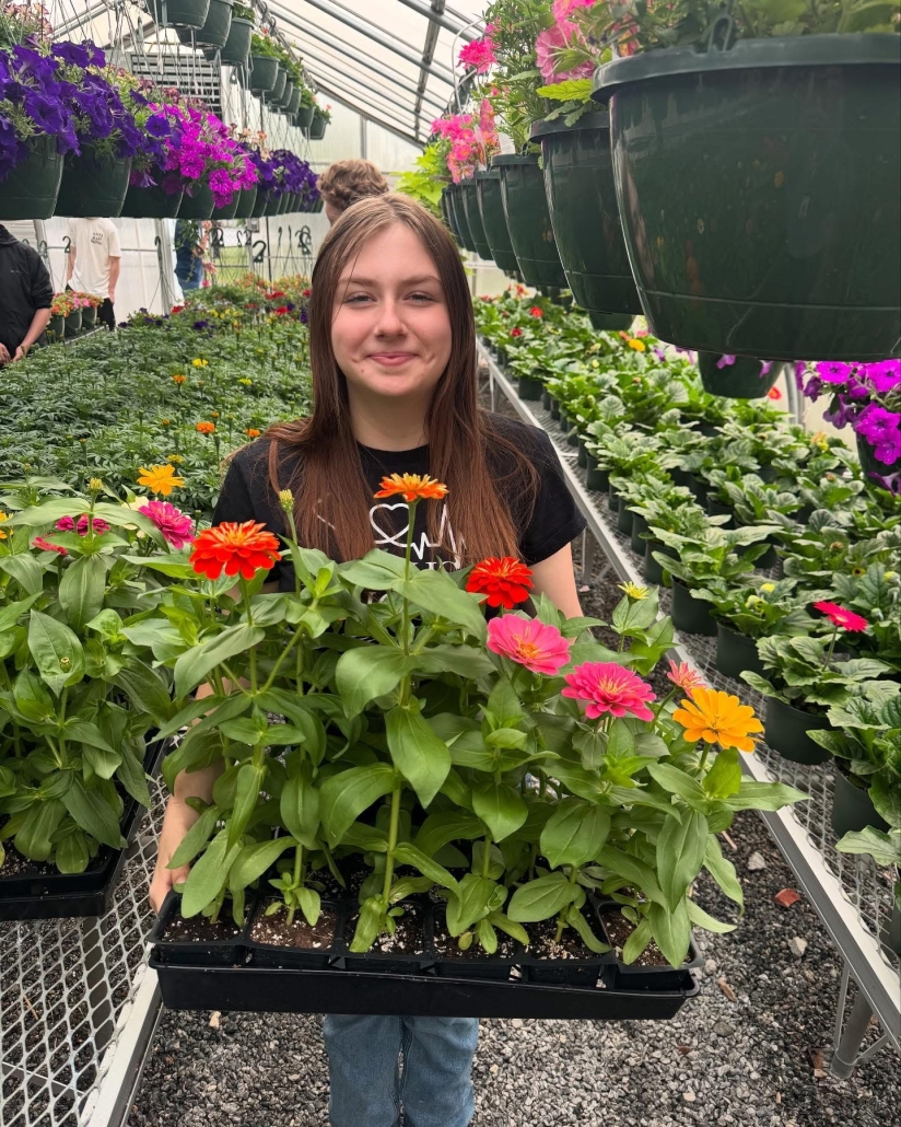 Hailey holding flat of flowers