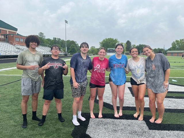 seven students all wet from water activities