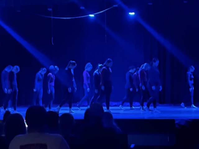 dancers in spotlight on stage