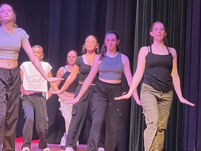 students dancing with hands down