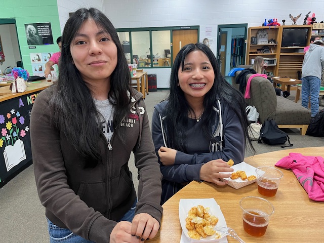 two girls enjoying tots