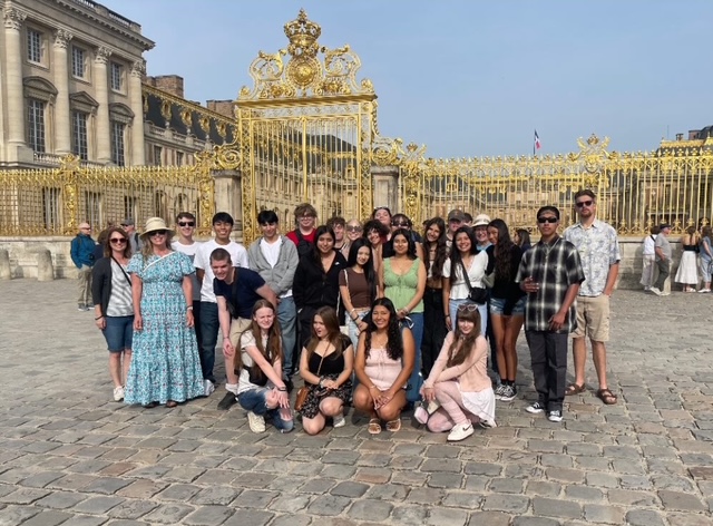 group photo in front of the gates at Versailles