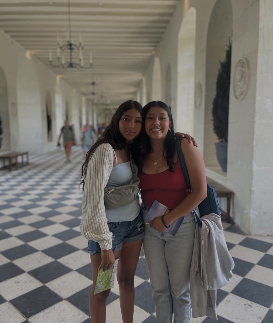 two girls in the hall of a castle