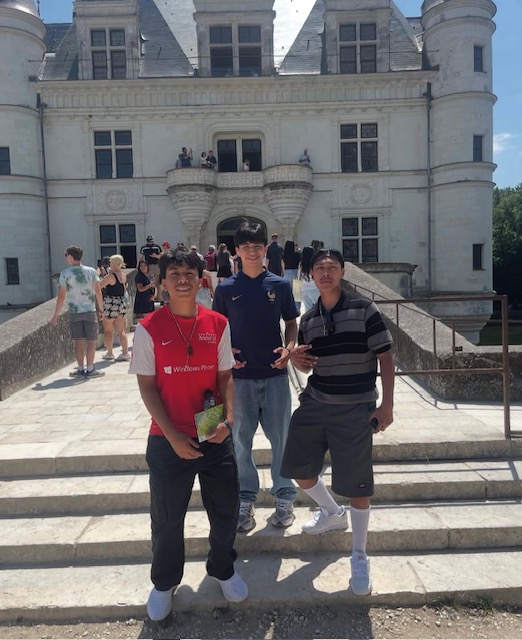 three boys on castle steps