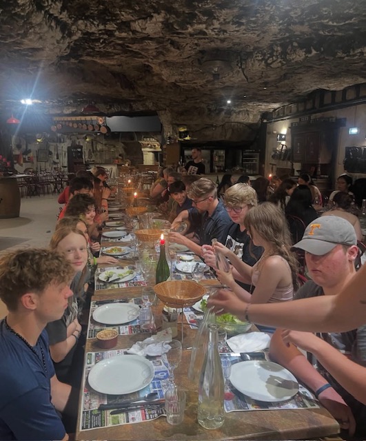 table photo of group in a cave