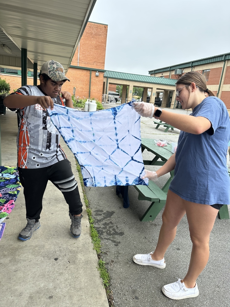 Hemore and Courtney holding up towel project
