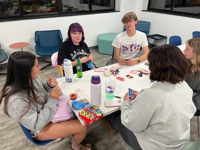 Students playing a game at a table