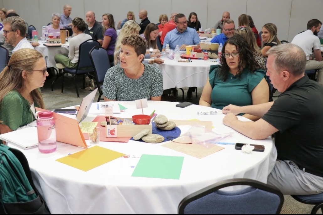 admin retreat photo at table