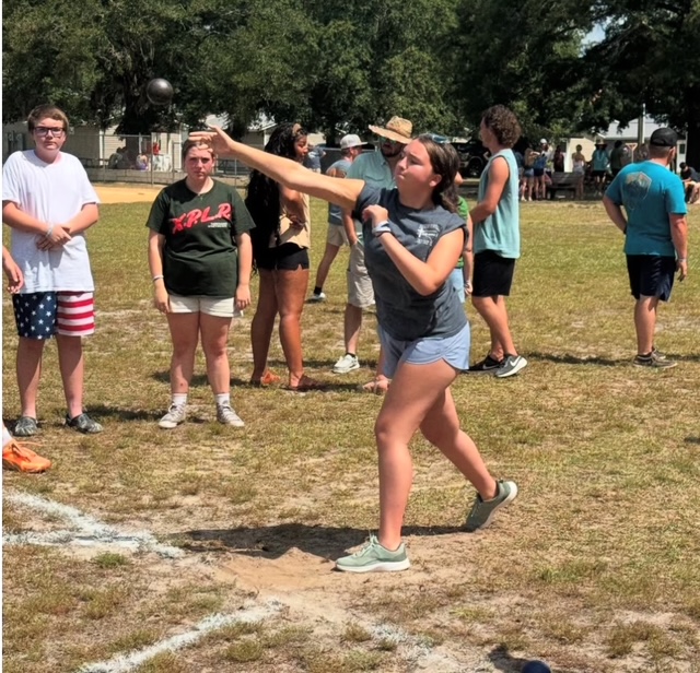 student throwing shot put