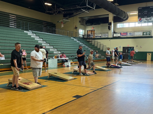 contestants playing cornhole
