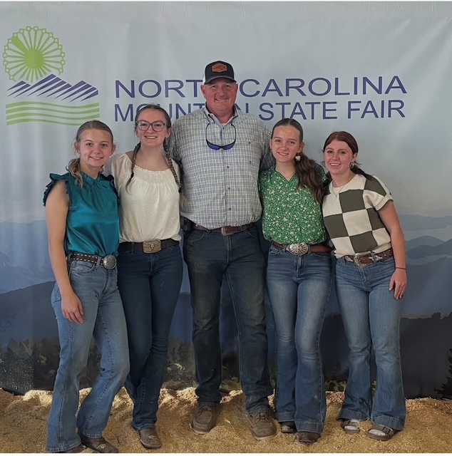 four girls with Mr. Rollins at fair