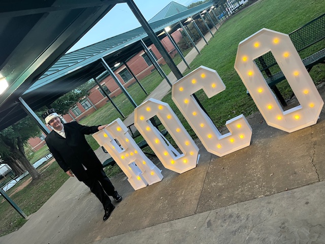 The Duke with HOCO sign