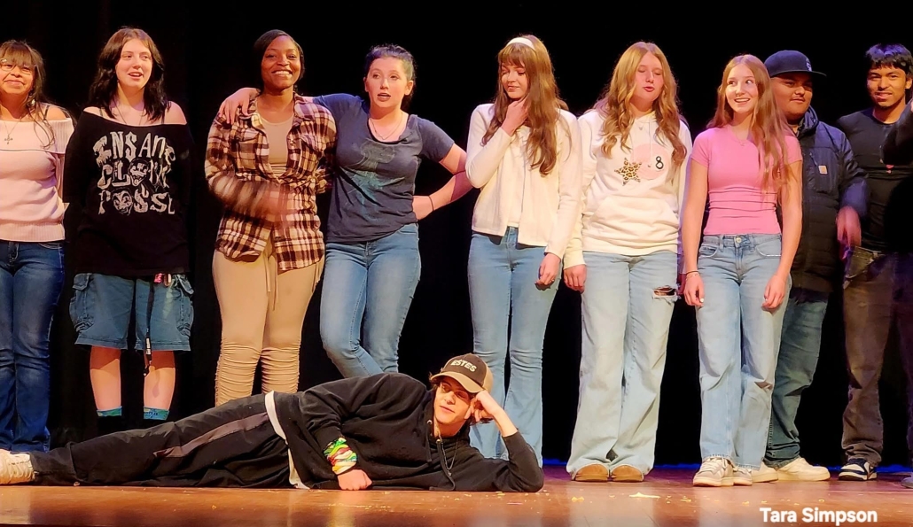 actors on stage with one laying down