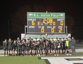 Soccer team with winning scoreboard in background