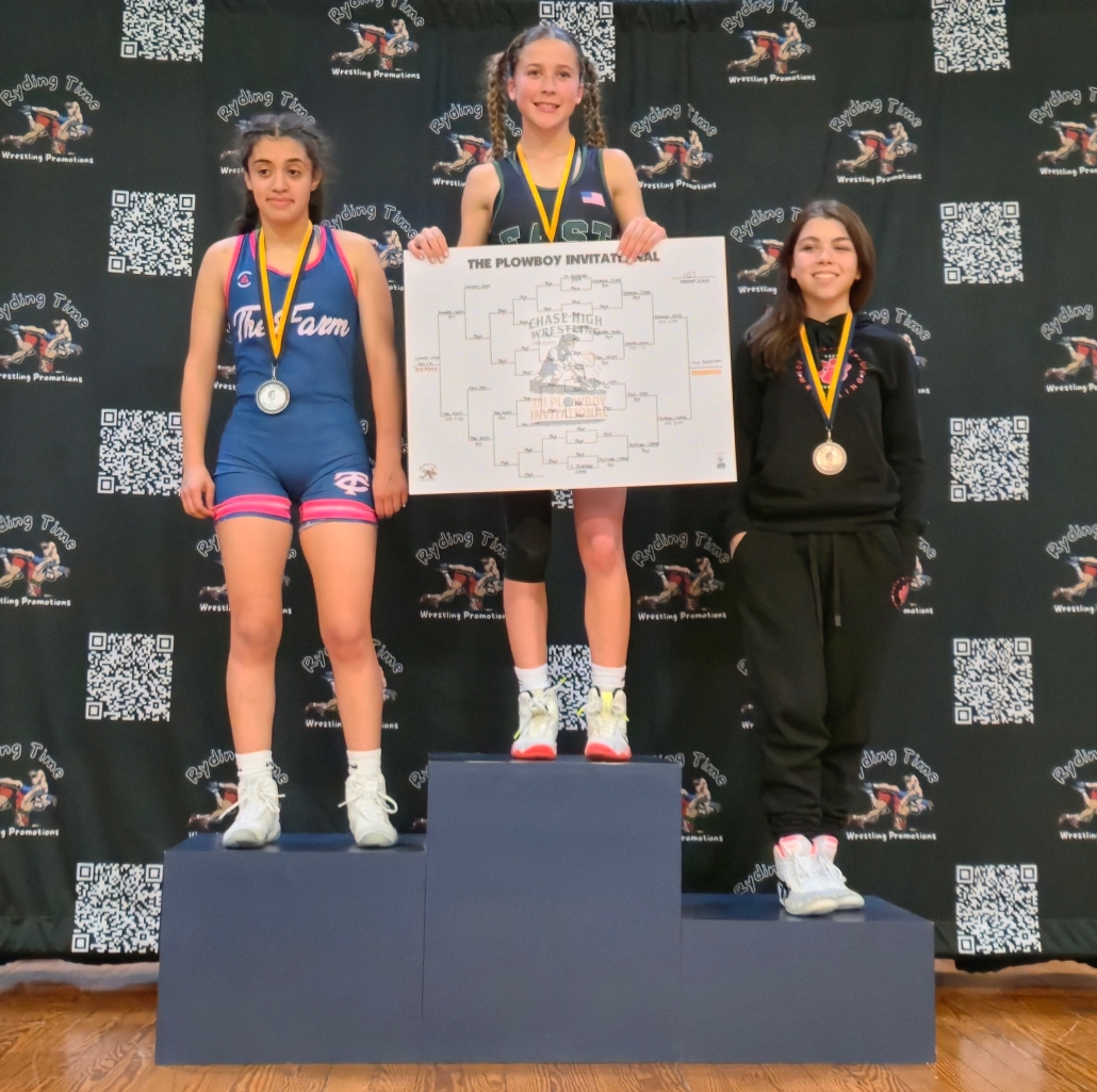 Mia on the podium holding bracket poster