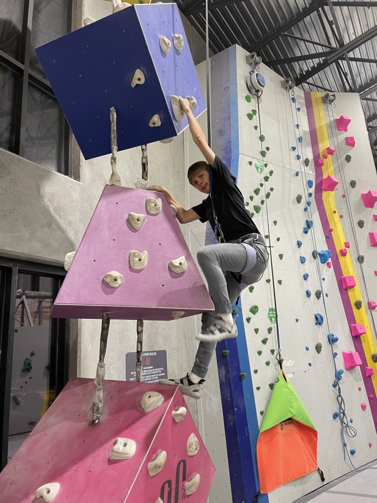 Jeremiah climbing a suspended obstacle