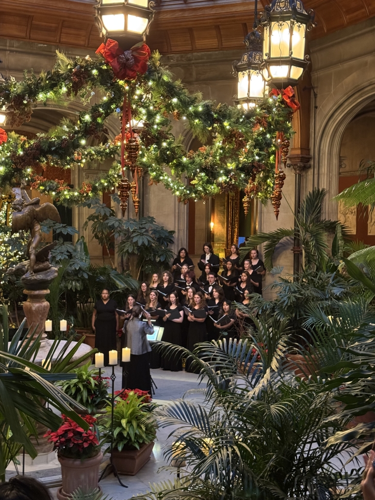 Chorus performing in the atrium of the estate