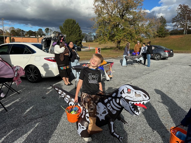 Boy in inflatable dinosaur costume