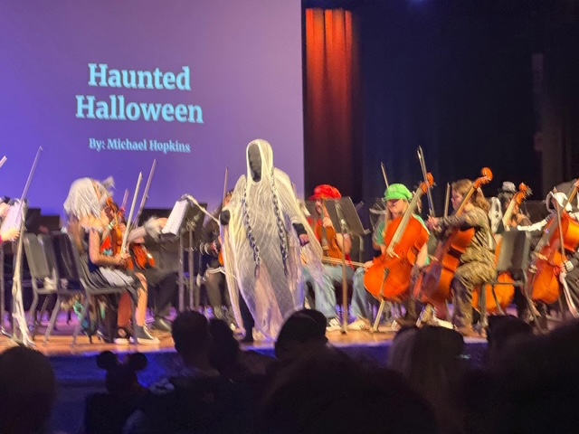 Mrs. Quinn in creep costume exiting the podium on stage