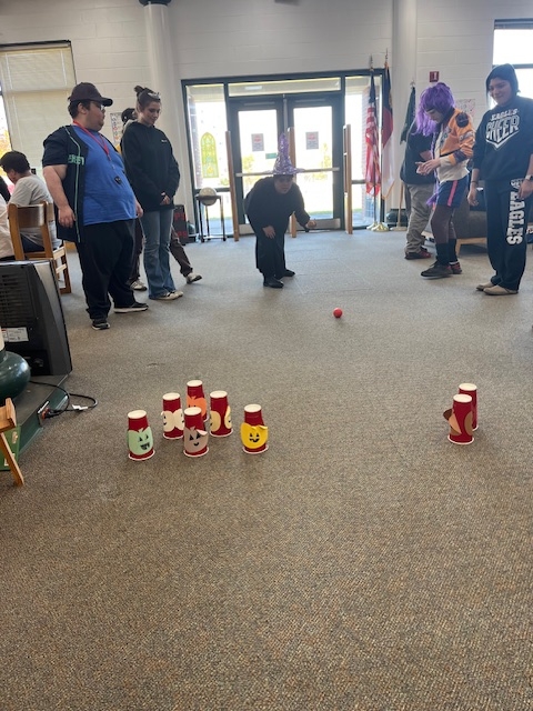 Mimi bowling with fans around her