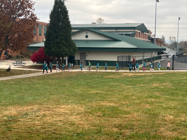 Kinder students walking up the back sidewalk