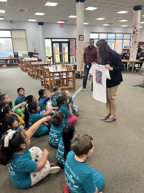 Dr. Marlowe asking students to point out the East pennant on the shirt