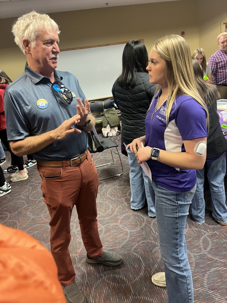 Arabella speaking with a conference presenter