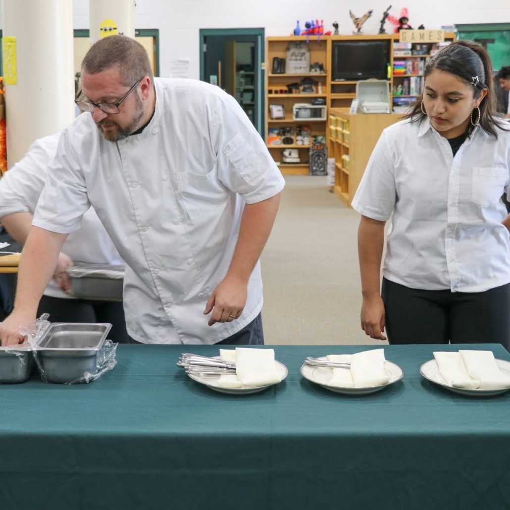 Chef Trey and students putting out finishing touches