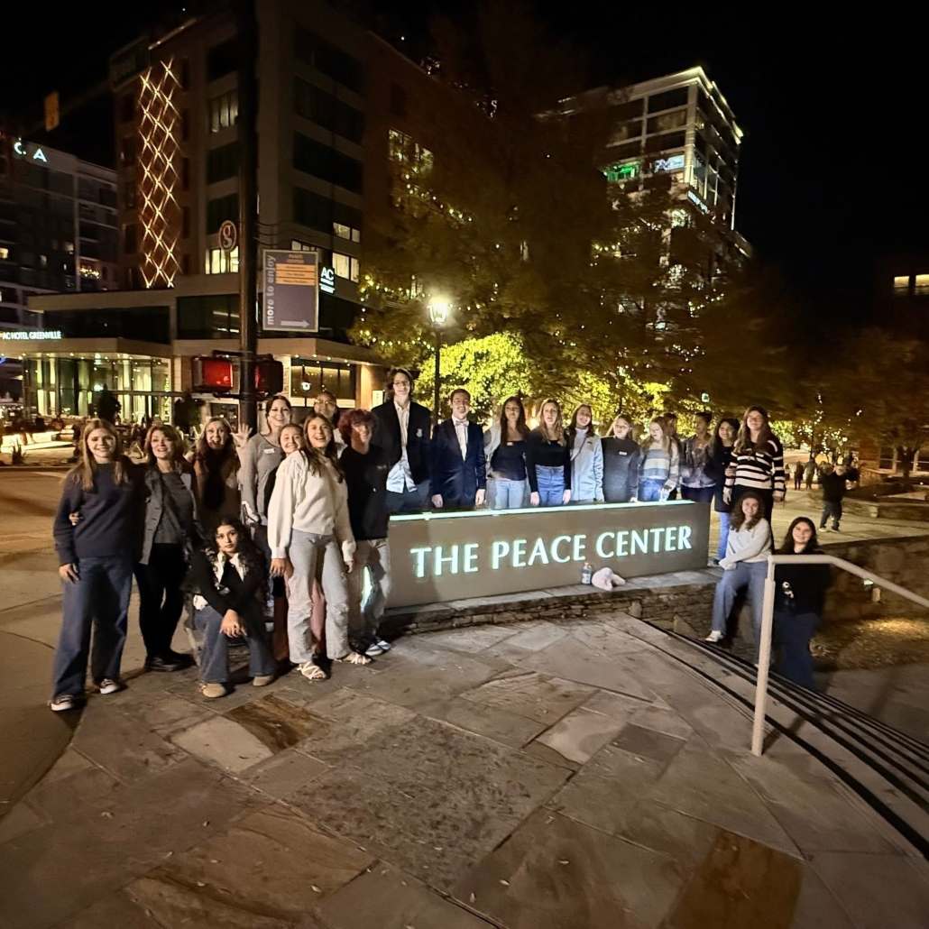 Group picture at the Peace Center sign