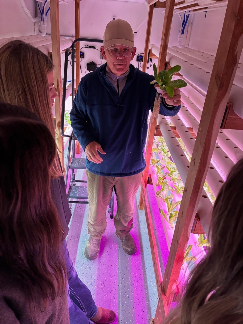 students learning about horticulture from local farmer