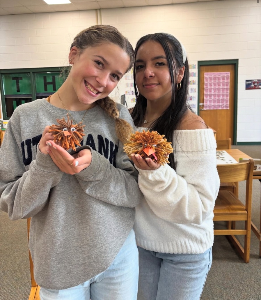 Two girls holding their puffy turkey crafts