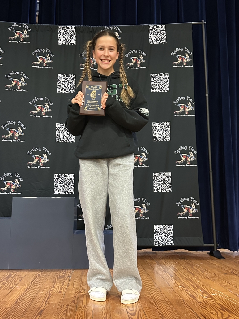 Mia on stage holding her MOW plaque