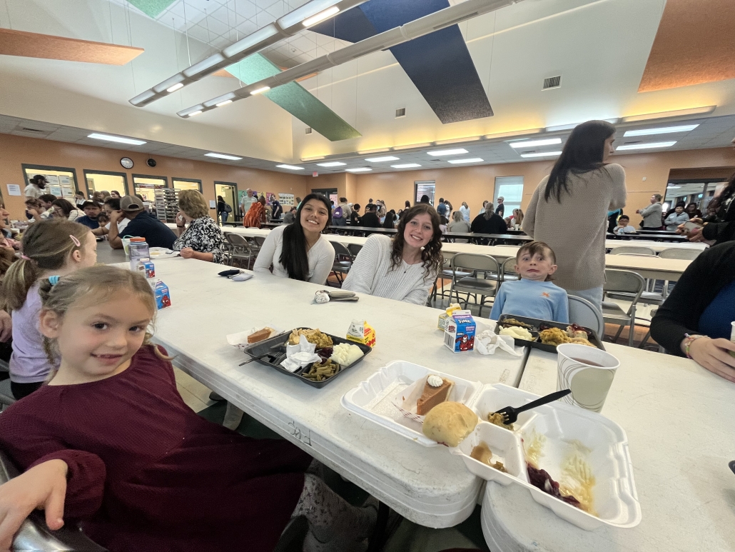 Andrea and Bella with Dana students celebrating Thanksgiving
