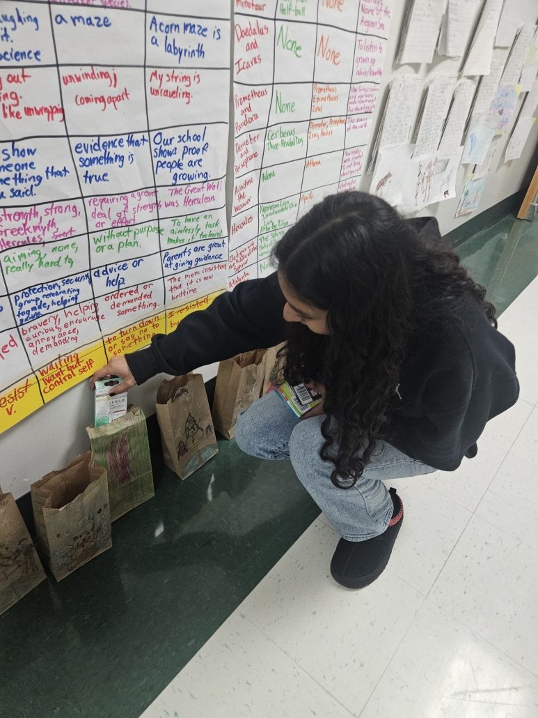 Melany filling a paper bag while squatting