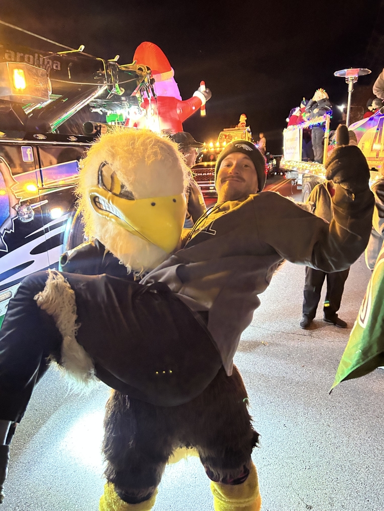 Swoop holding Coach Brackett