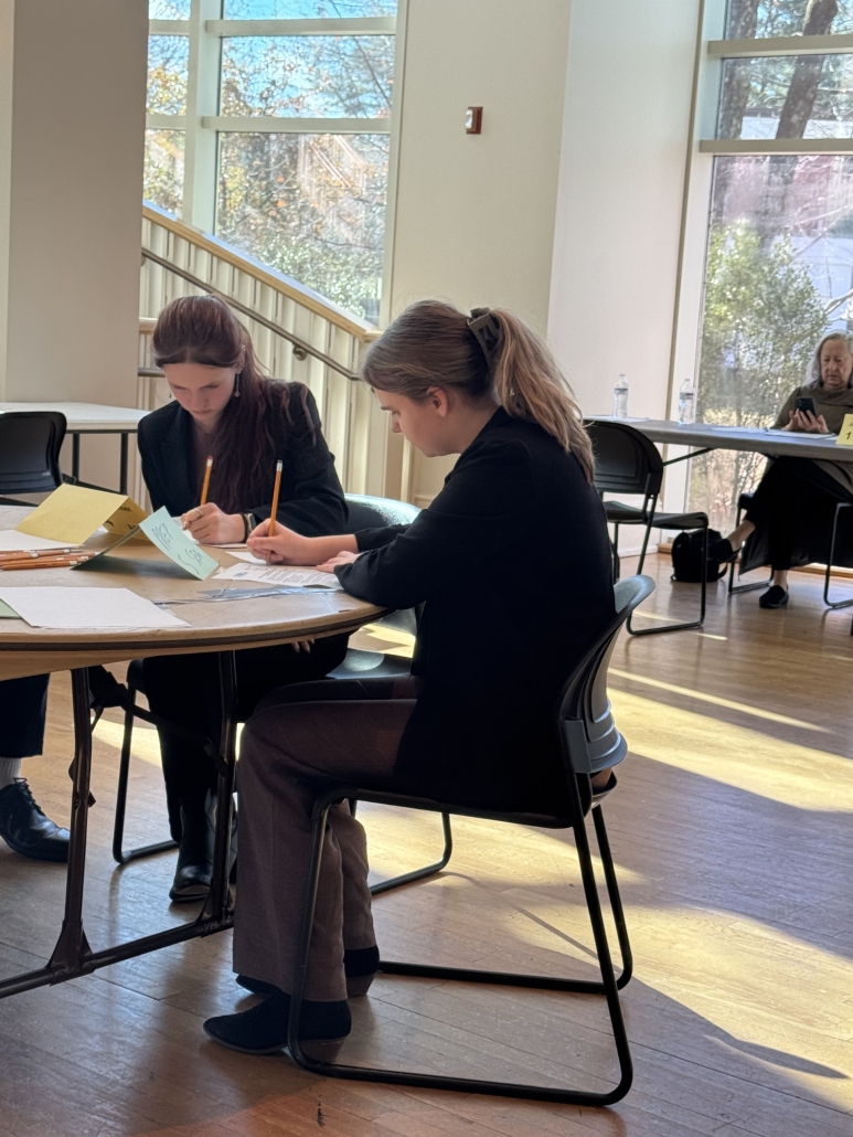 Two DECA students working on their test