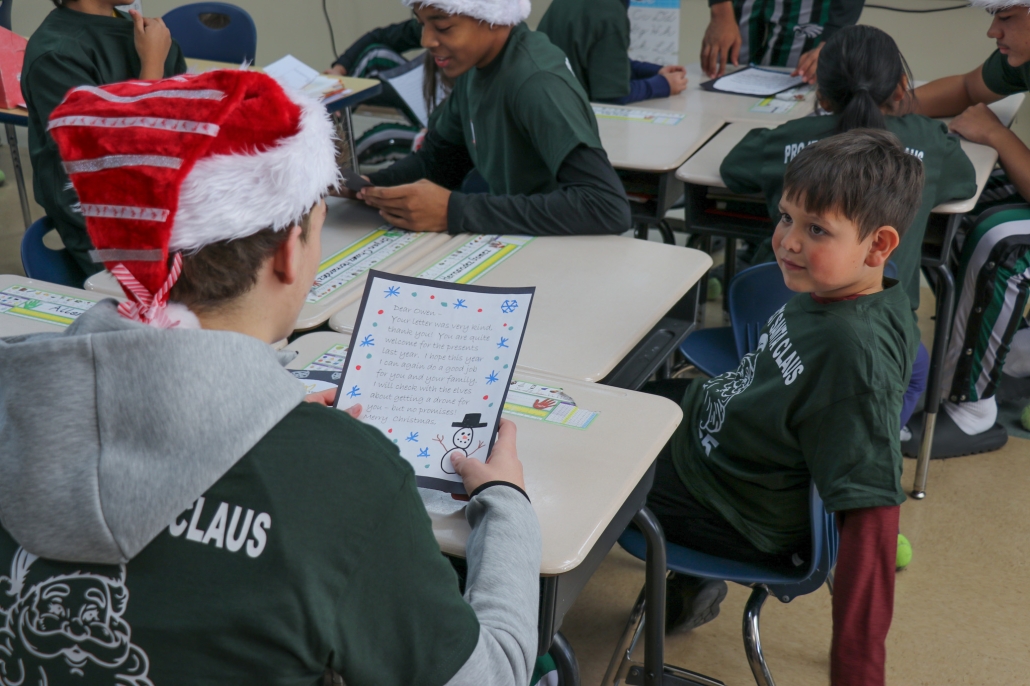 Basketball player reading a letter to a little boy