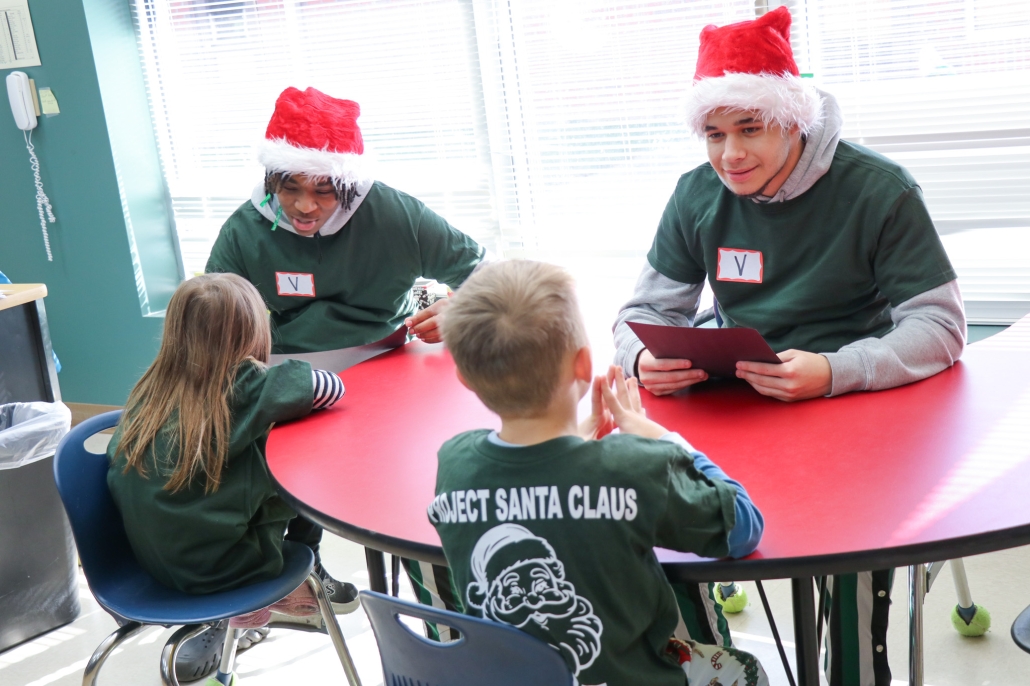 Two basketball player and Hillandale student pairs at a table